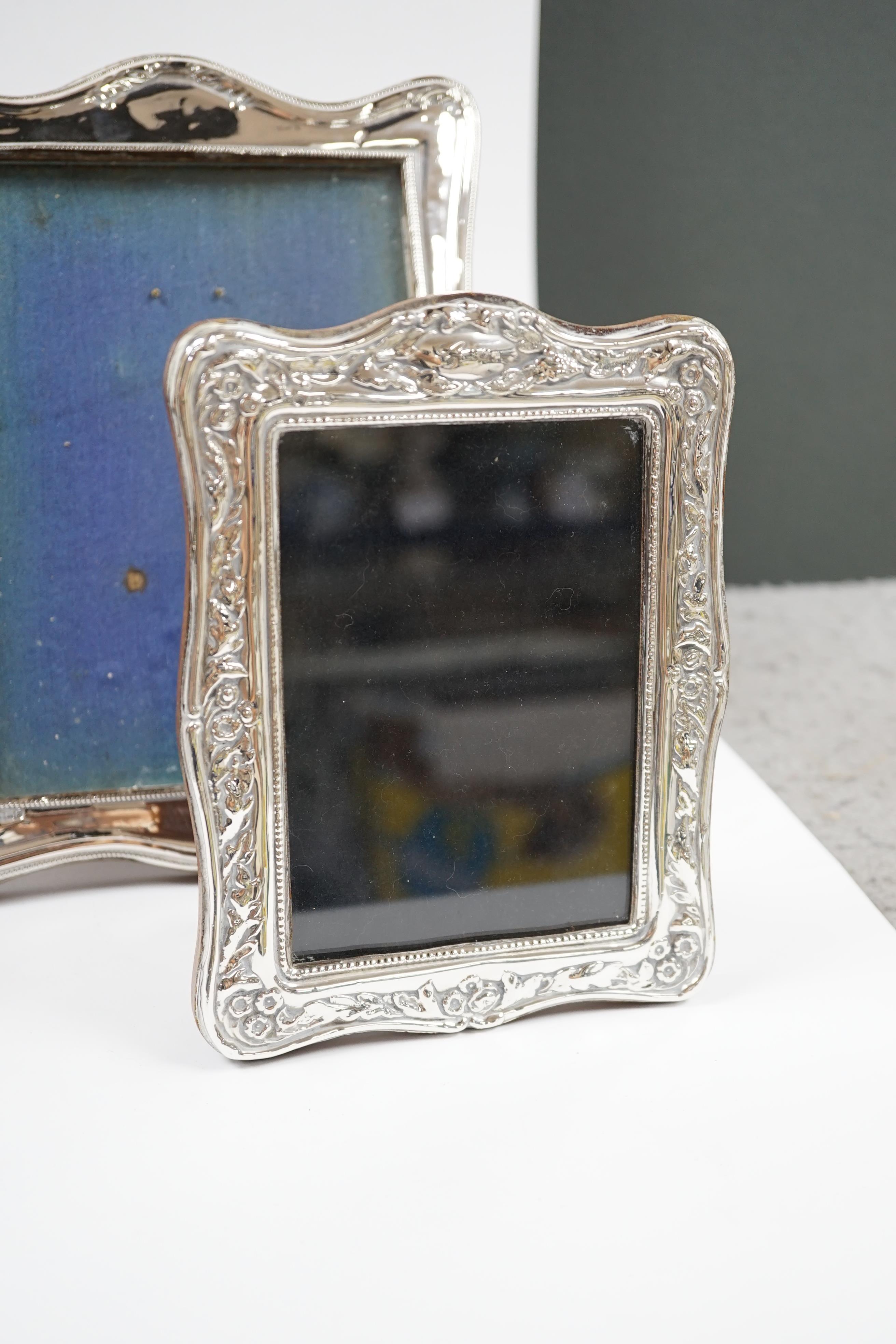 A George V silver mounted photograph frame, Birmingham, 1917, 25cm, together with a modern silver mounted photograph frame. Condition - poor to fair